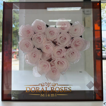 Doral Roses Miami floral box with 16 preserved pink roses arranged in a heart shape, perfect for special occasions.
