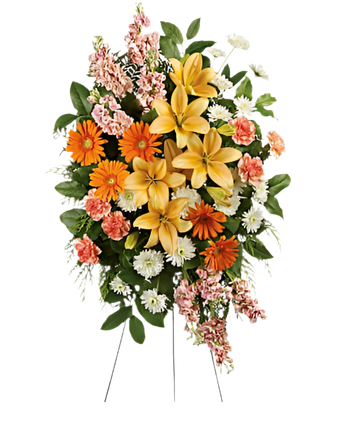 Arreglo funerario con lirios frescos y yerberas en tonos melocotón y naranja para condolencias en Miami